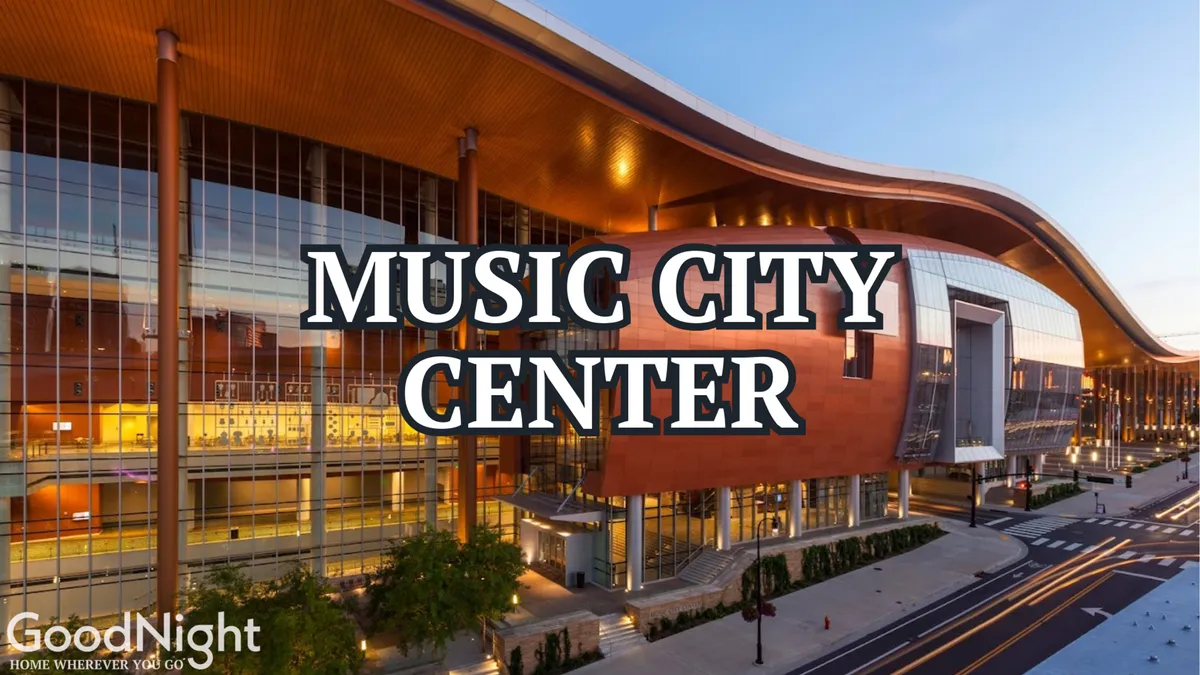 A striking view of the Music City Center building with its sweeping glass facades and unique curved roof, set against the cityscape. The area is bustling, showcasing the venue’s energy and proximity to downtown attractions.