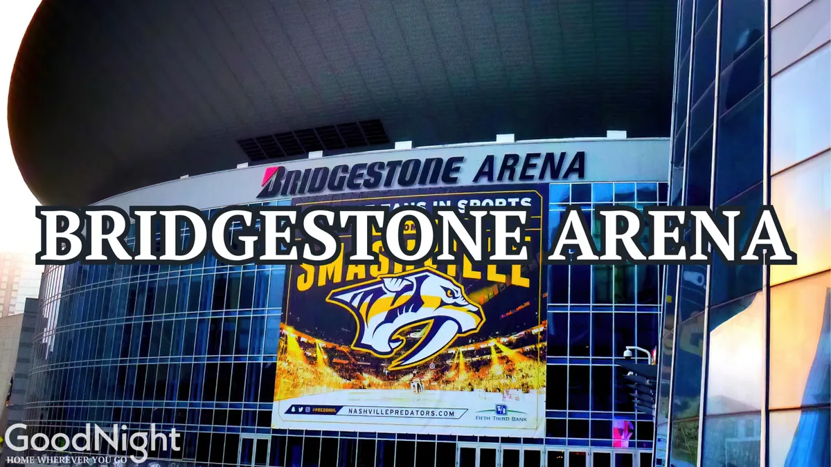 Bridgestone Arena’s iconic exterior, featuring the recognizable sign and a large Nashville Predators banner, set amidst the city’s vibrant streetscape. The arena is a hub for sports, concerts, and after-hours entertainment.